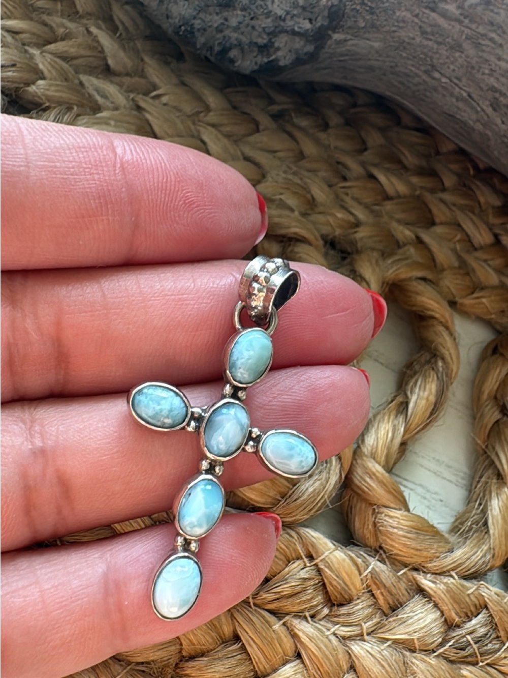 Larimar cross pendant features natural blue stones bezel-set in sterling silver